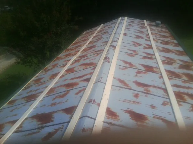 Rusted metal roof panels with new wood purlins before replacement — Storm Damage Roof Repair in Lambertville by Roofing Brothers